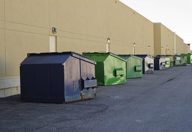 a construction worker disposing of debris into a dumpster in Plantation